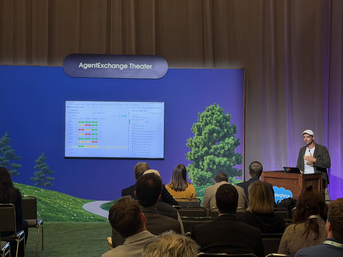Daniel Kallestrup of ARPEDIO demoing live on the AgentExchange Theater stage at Dreamforce 2026, with the ARPEDIO relationship view on the big screen