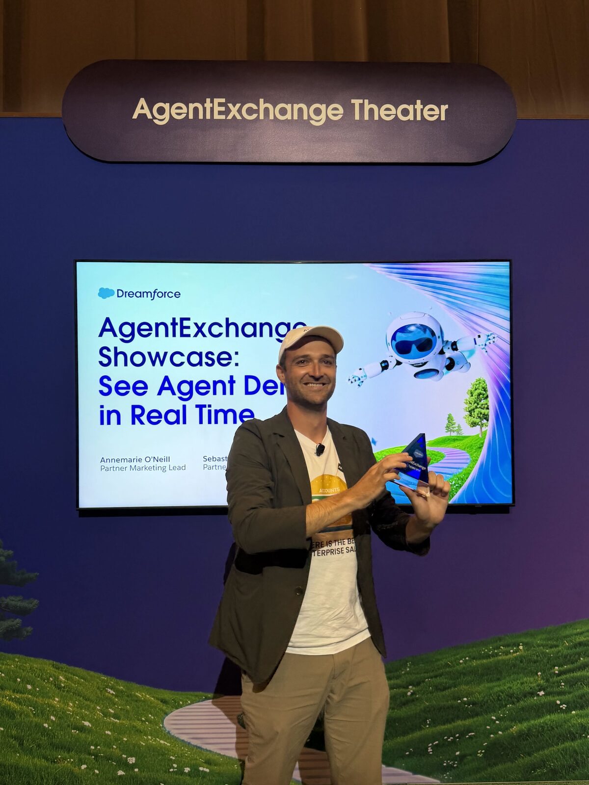 Daniel Kallestrup of ARPEDIO holding the Demo Jam trophy on the AgentExchange Theater stage at Dreamforce 2026