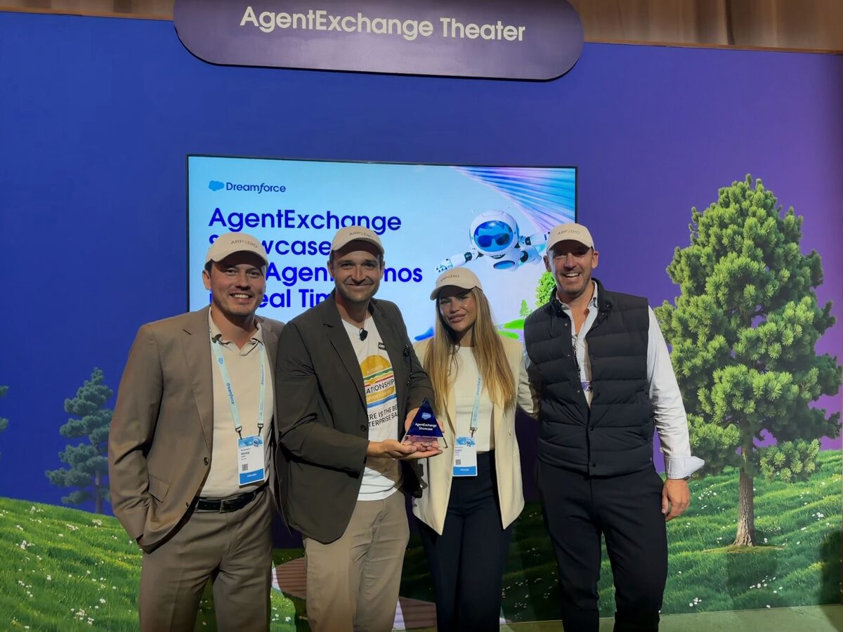 Four members of the ARPEDIO team on the AgentExchange Theater stage at Dreamforce 2026 holding the Demo Jam trophy